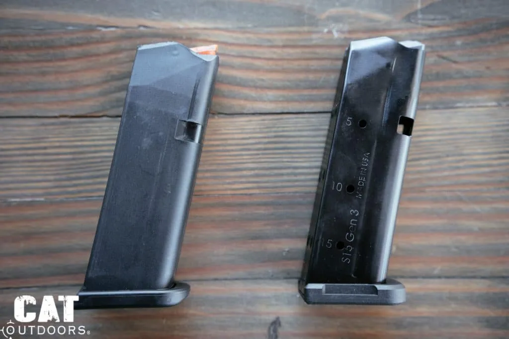 Factory polymer Glock magazine with orange follower beside a Shield Arms S15 Gen 3 steel magazine