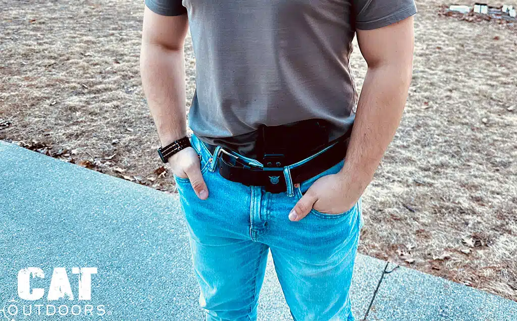 Appendix carry with the Glock 43X in a black IWB holster, gray tee draped over the grip