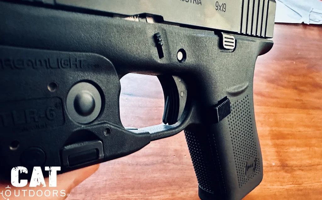 Close look at the slimline trigger and its safety blade on the 43X, TLR-6 light on the guard