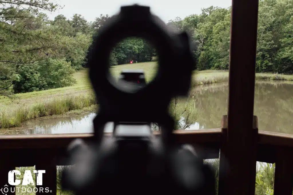 Red dot held on a distant target at the far tree line, seen through the Romeo 5