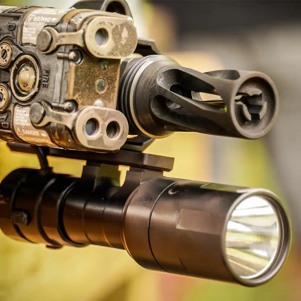 Cloud Defensive REIN 3.0 Micro mounted under a worn tan laser unit beside the muzzle device