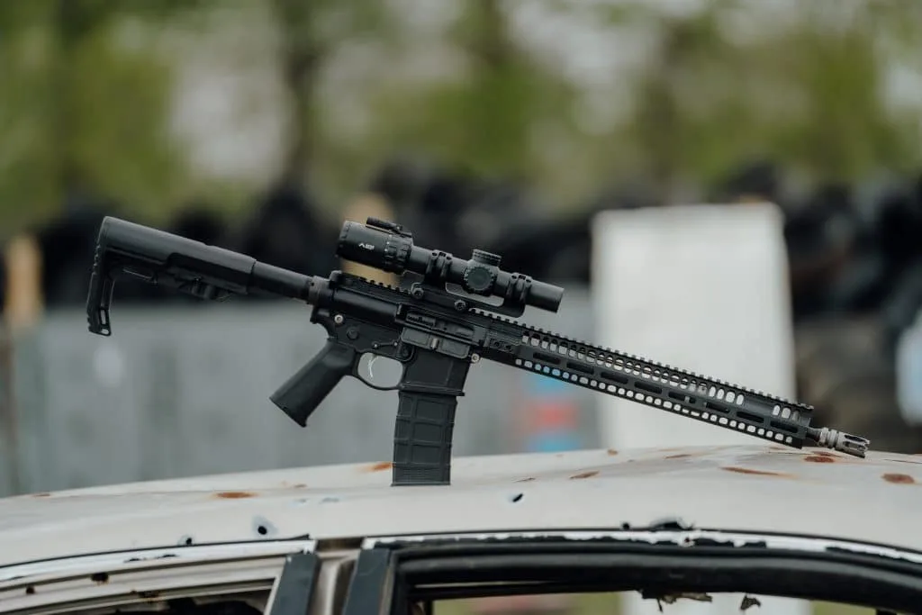 Primary Arms SLx 1-6x Gen IV LPVO on an AR-15 perched on a shot-up car roof