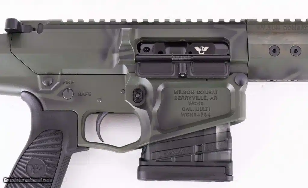 Close-up of a Wilson Combat WC-10 receiver set in green camo with a smoked translucent magazine