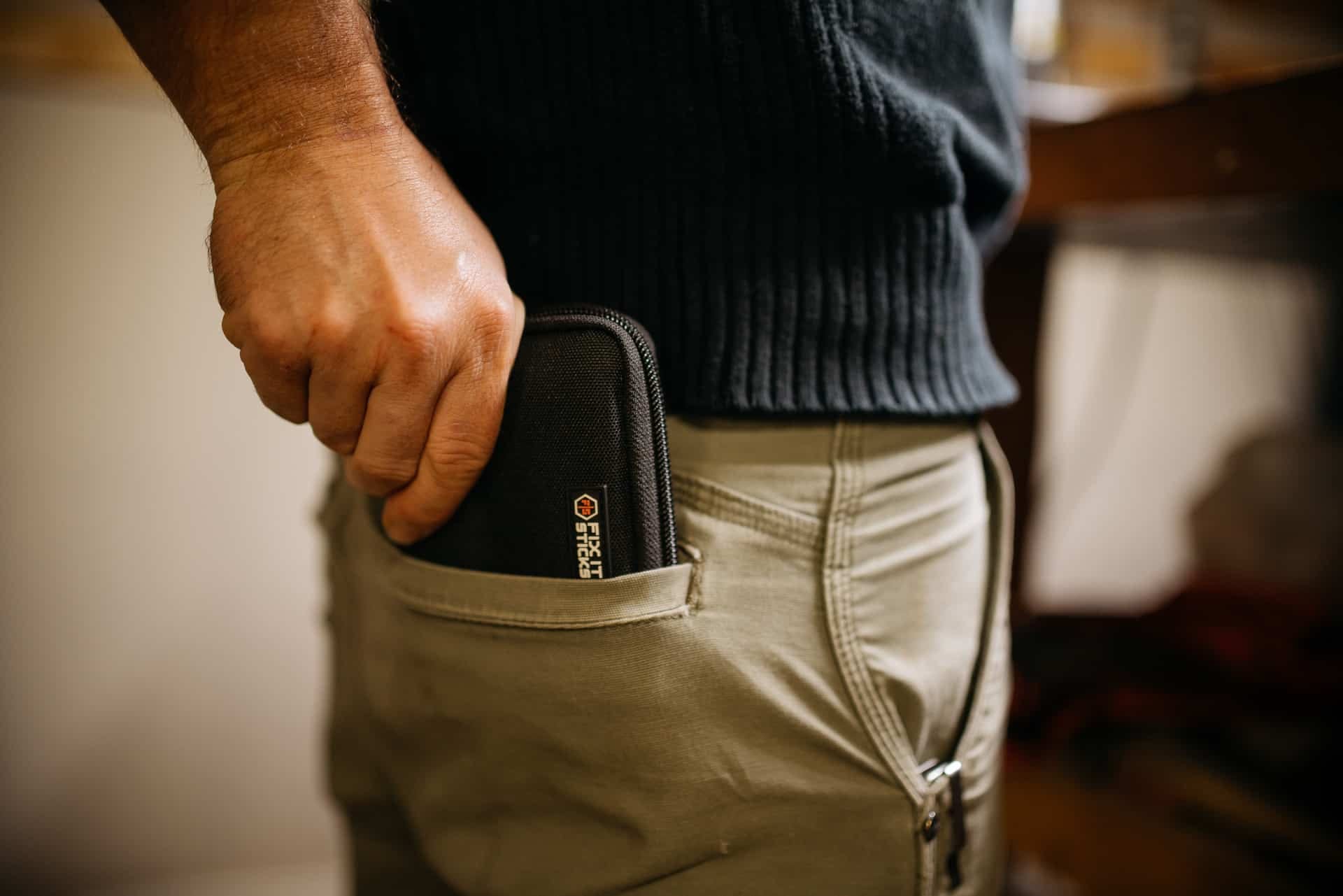 Fix It Sticks case sliding into a back pocket