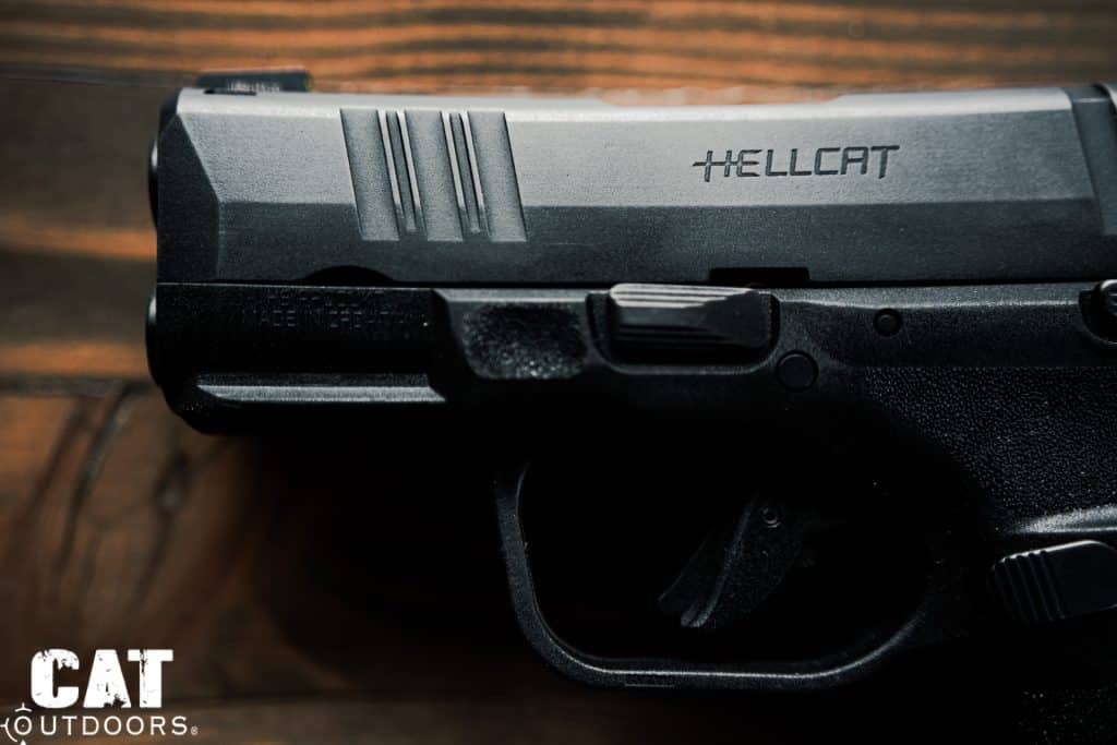 Side profile of the Springfield Hellcat slide showing front cocking serrations, the HELLCAT engraving, accessory rail, and solid slide top