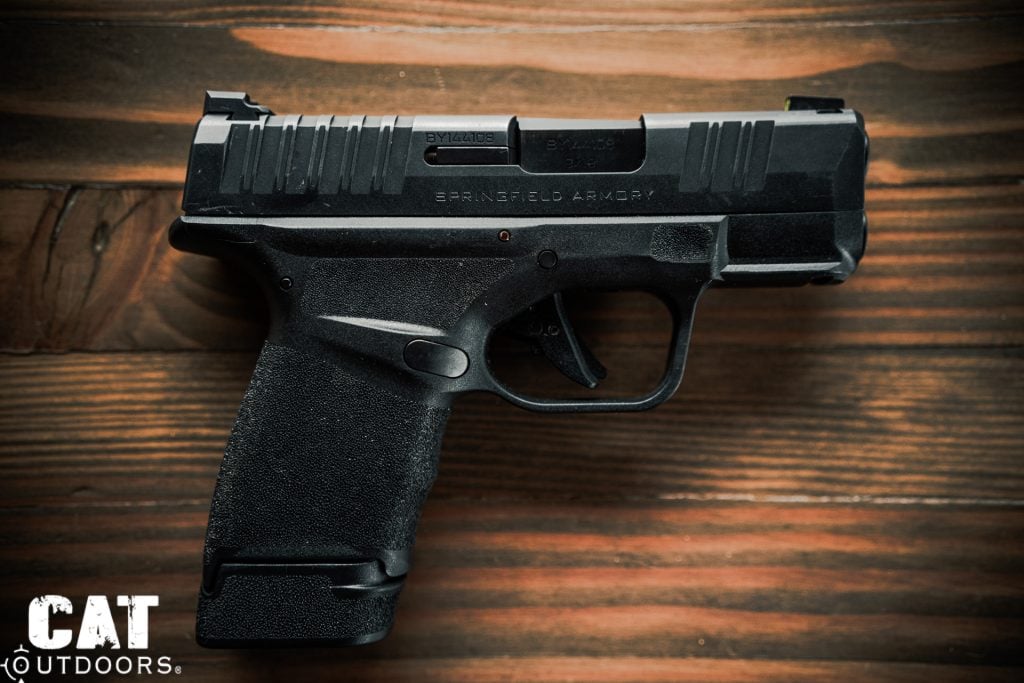 Right-side profile of the Springfield Hellcat 9mm with 11-round flush magazine inserted, showing slide markings, accessory rail, and front sight tritium