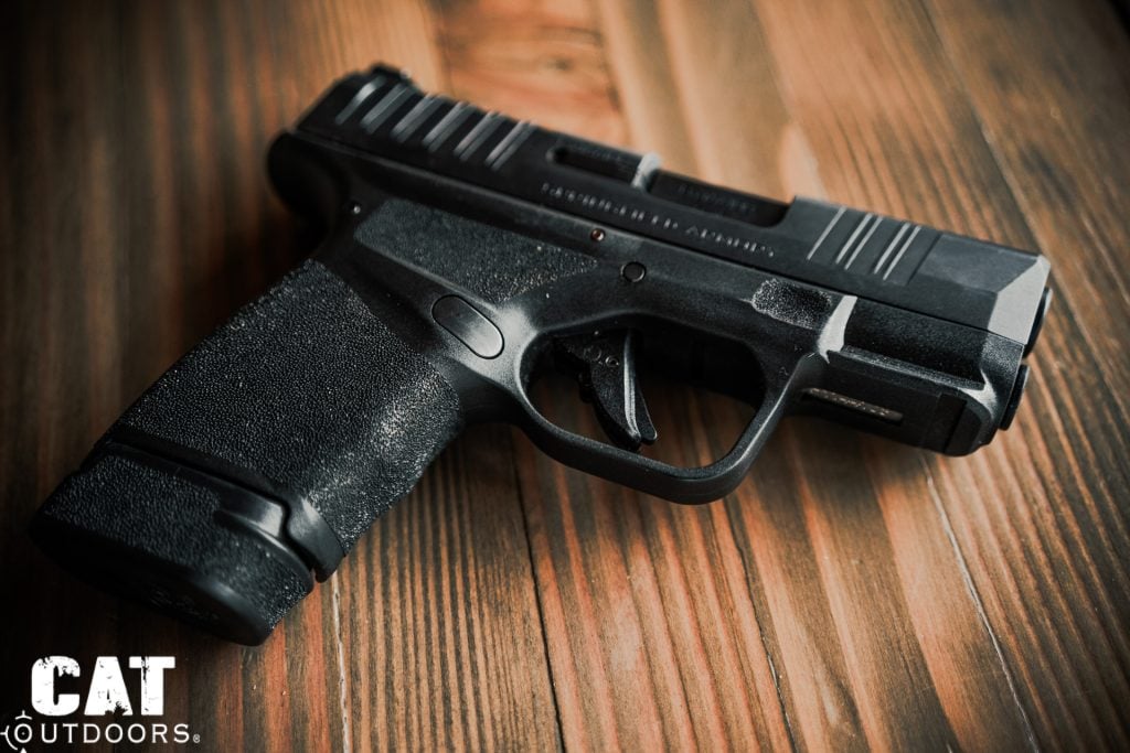 Macro close-up of the Springfield Hellcat Adaptive Grip Texture showing the staggered pyramid pattern across the grip panel