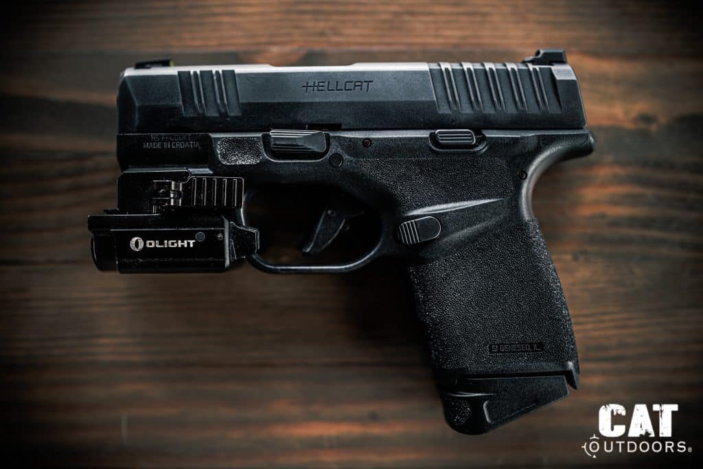 Springfield Hellcat side profile with Olight Baldr Mini mounted to the rail and 11-round flush magazine inserted