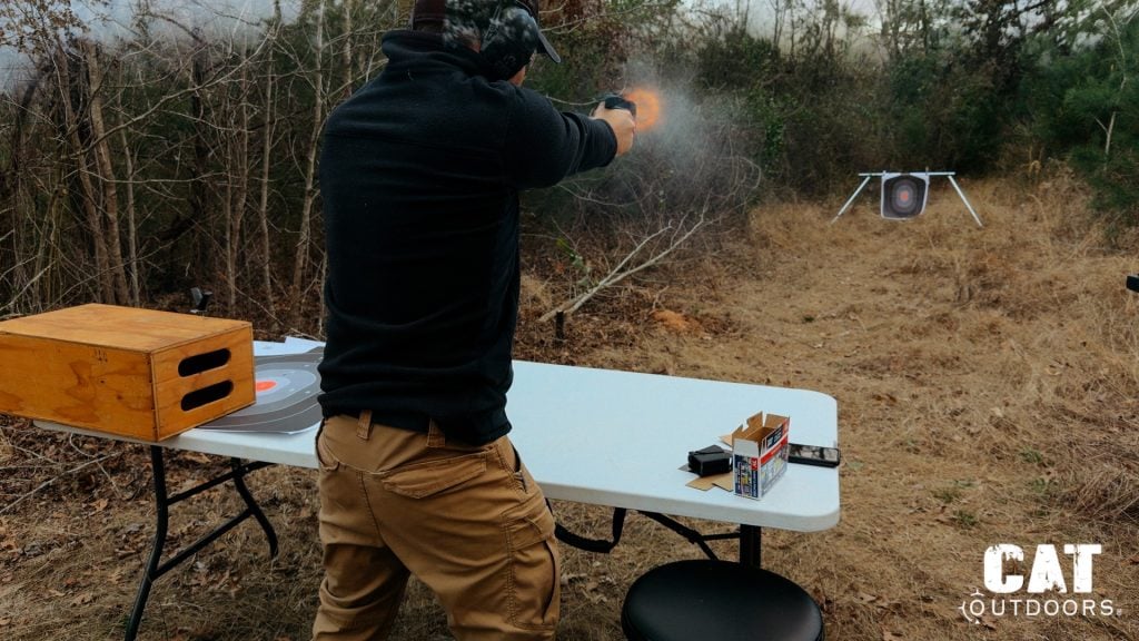 Brad firing the Springfield Hellcat from a standing position with visible muzzle flash and target downrange