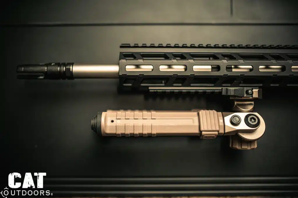 Side profile of CVLIFE FDE bipod folded along suppressed AR-15 rifle