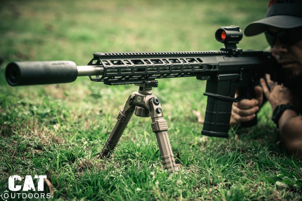 Shooter in prone position firing AR-15 with CVLIFE FDE bipod deployed