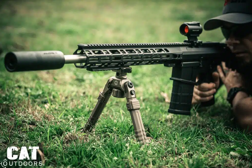 Shooter in prone position firing AR-15 with CVLIFE FDE bipod deployed