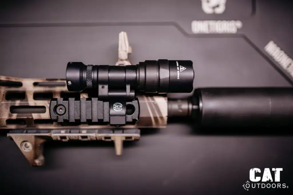 Light mounted via Picatinny rail adapter directly onto an FDE M-LOK handguard, top-down view