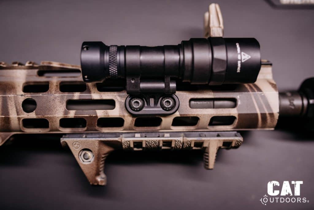 Light mounted via M-LOK adapter directly onto an FDE M-LOK handguard, top-down view