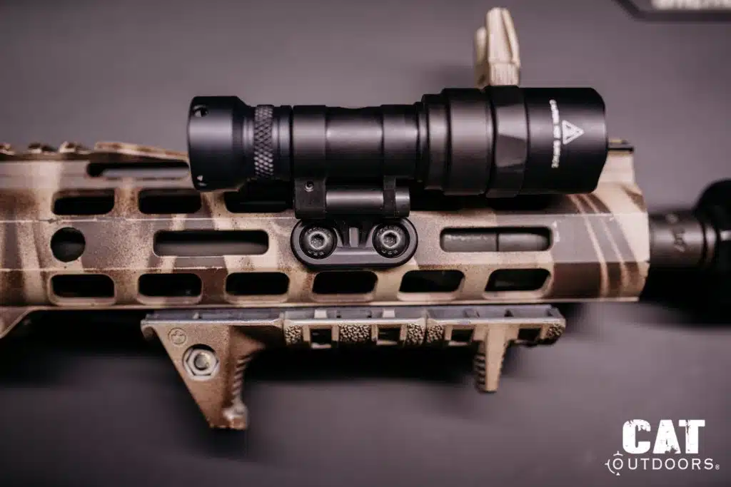 Light mounted via M-LOK adapter directly onto an FDE M-LOK handguard, top-down view