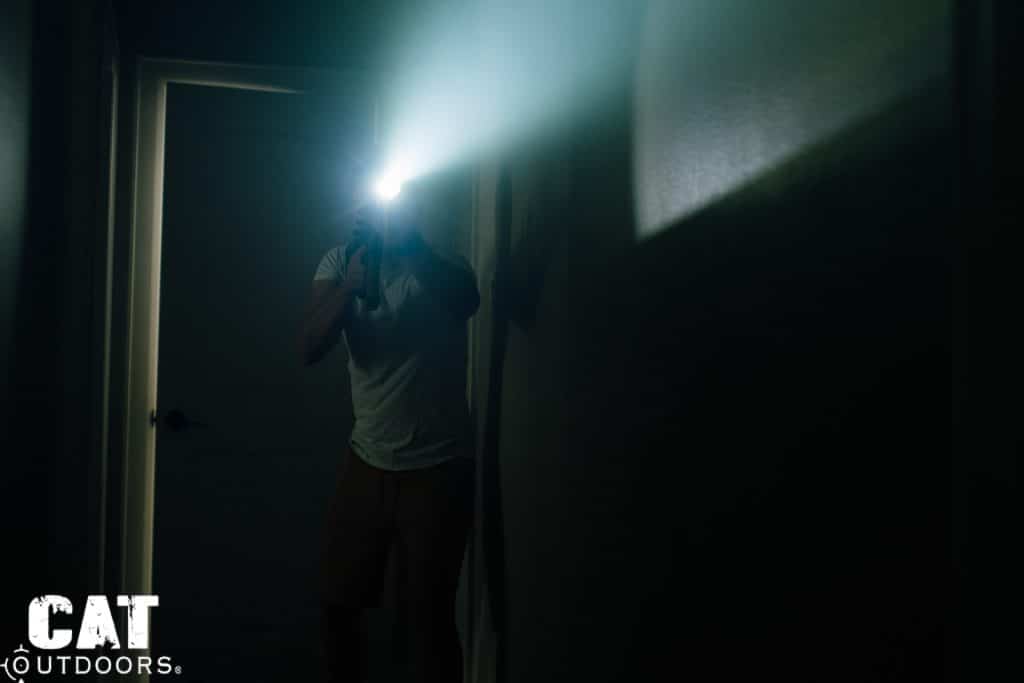 Brad activating the SureFire M340C-PRO Mini Scout Light Pro in a dark hallway, beam splash visible on walls and ceiling