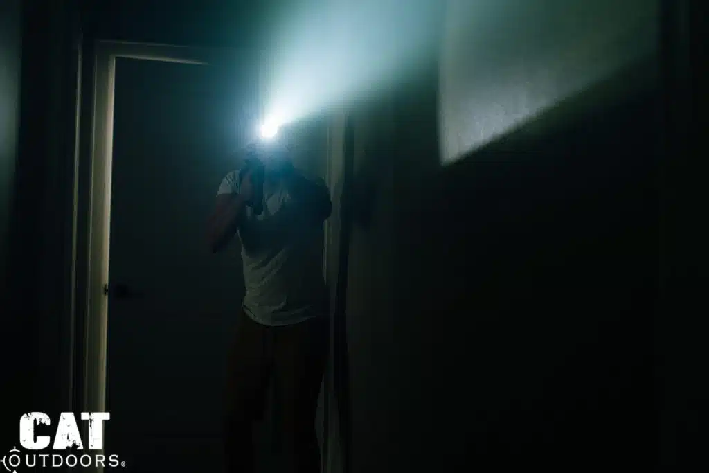 Brad activating the SureFire M340C-PRO Mini Scout Light Pro in a dark hallway, beam splash visible on walls and ceiling