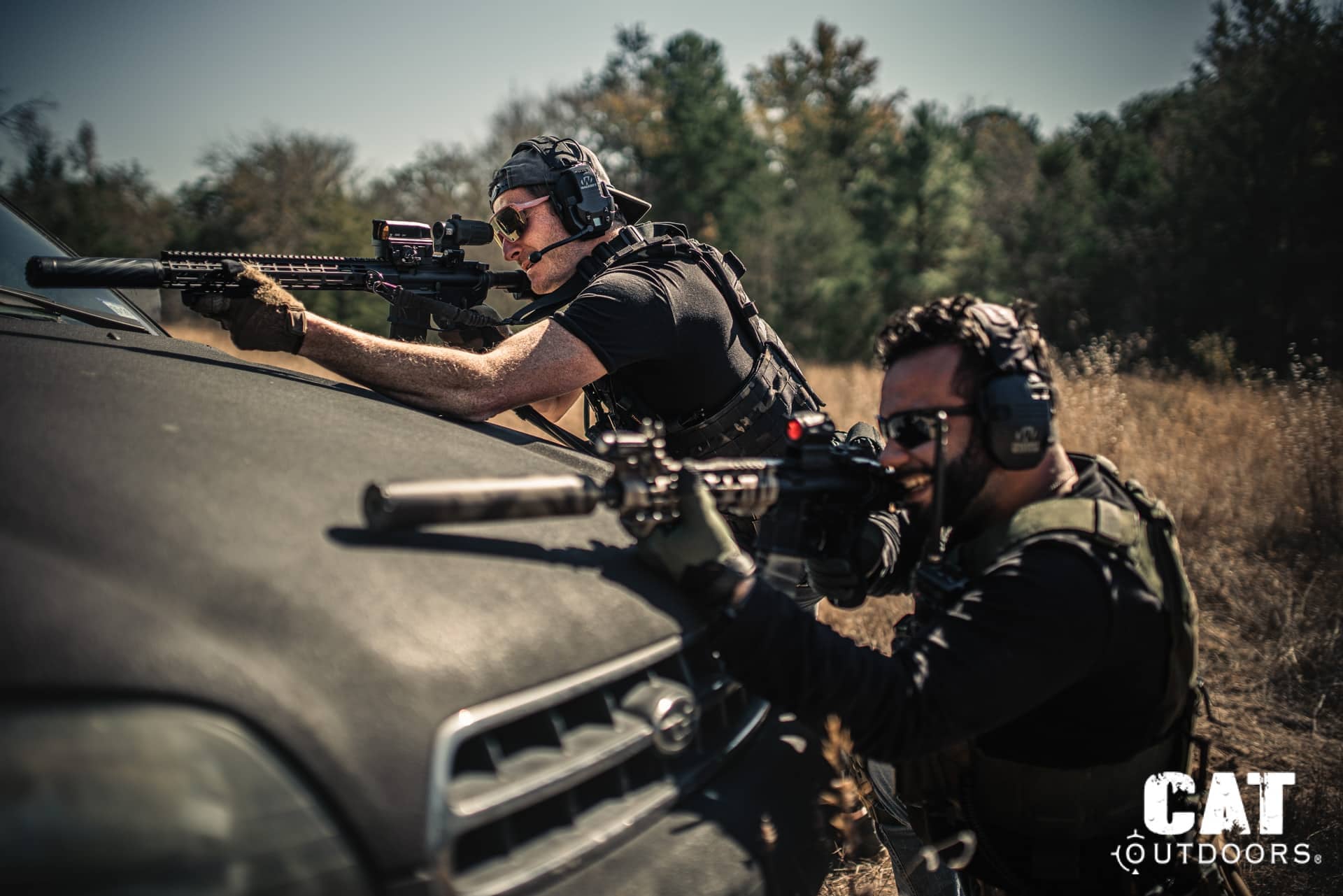 CAT Outdoors team members during a live-fire training session, running AR-15 rifles from vehicle cover