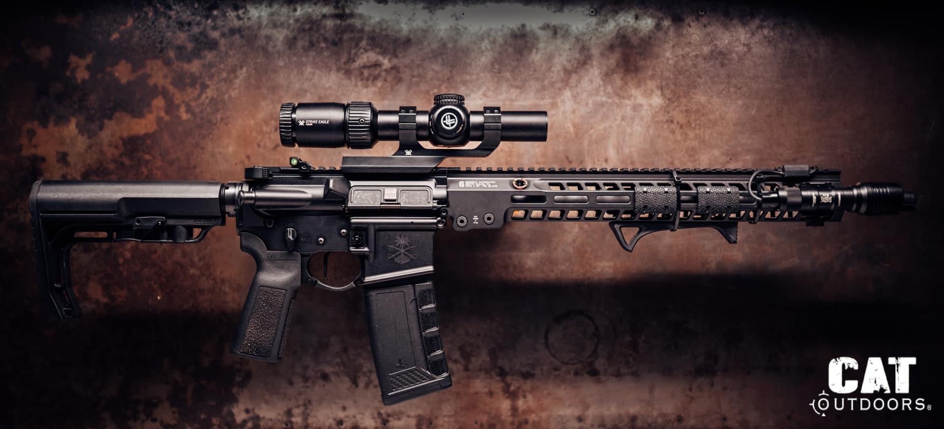 AR-15 test rifle with TriggerTech Diamond trigger installed, Vortex Strike Eagle LPVO and weapon light, on a rusted steel background