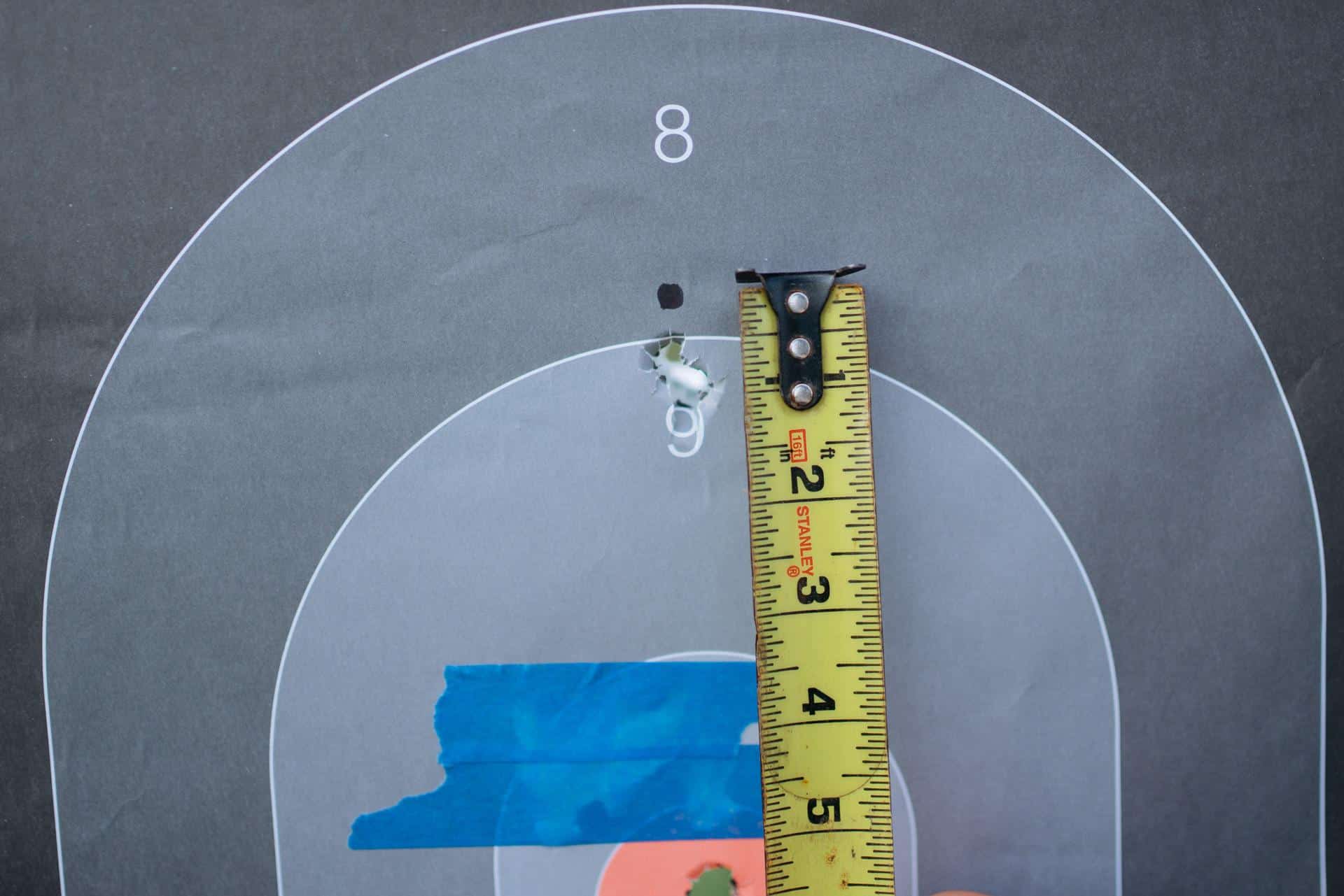 Baseline 25-yard group measured with a tape, landing where expected for a provisional 50-yard zero