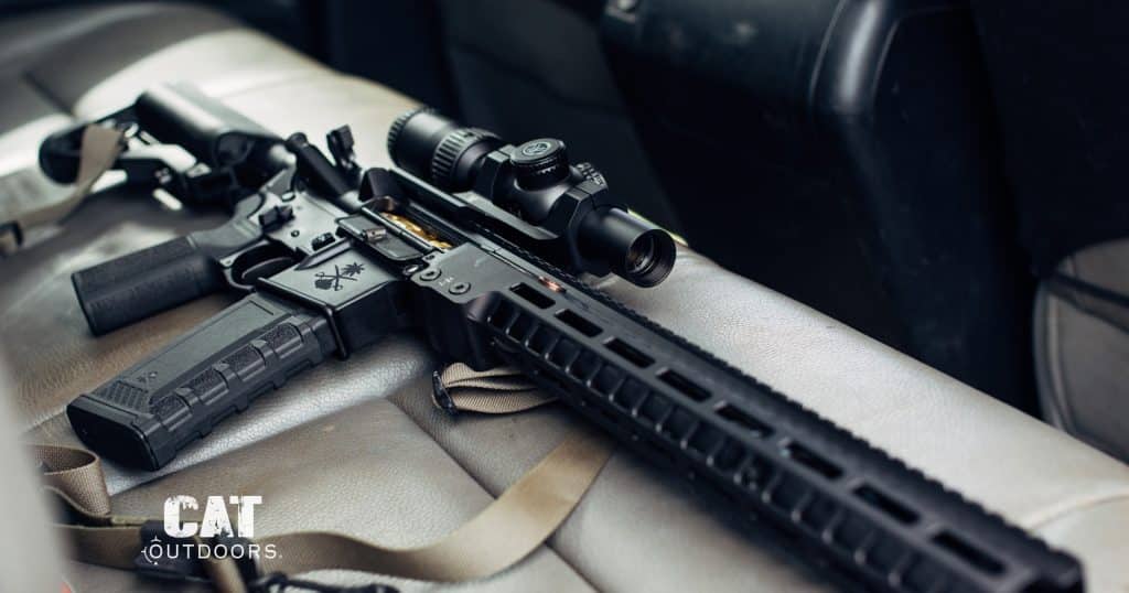 Semi-automatic AR-15 rifle with a detachable magazine on a truck seat