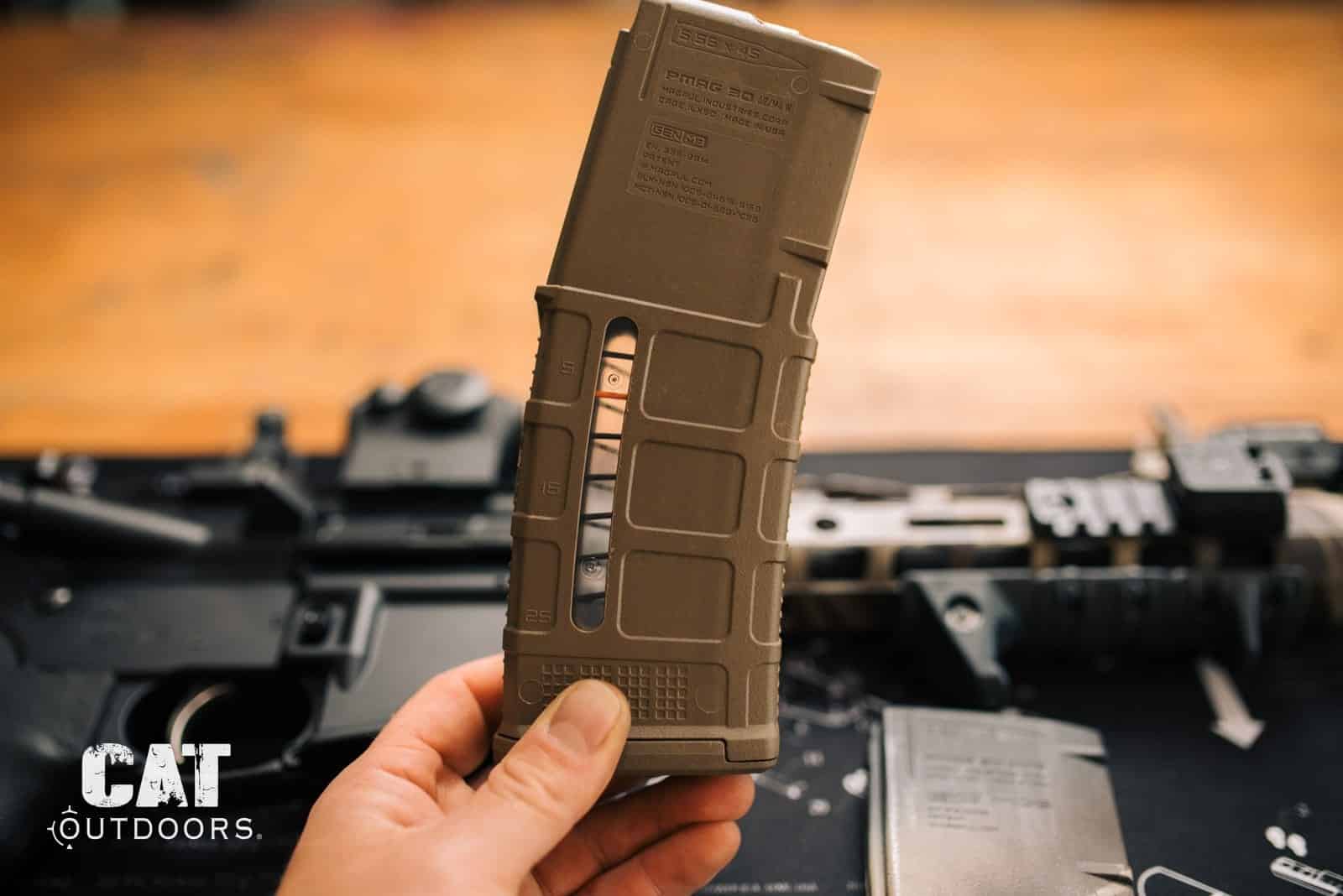 Magpul PMAG 30 AR/M4 GEN M3 5.56 magazine held above an AR-15 lower receiver