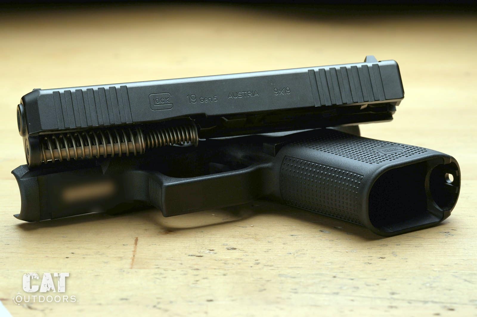 Glock 19 Gen 5 slide lifted off the frame showing the barrel and recoil spring assembly