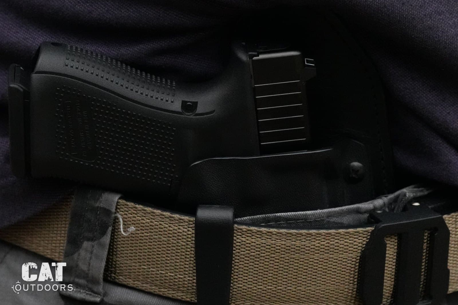 Close-up of the Glock 19 Gen 5 in an inside-the-waistband holster on a nylon belt