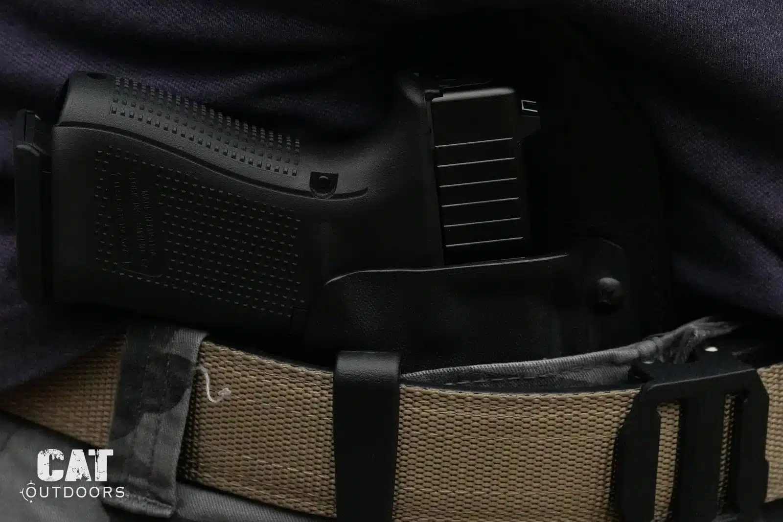 Close-up of the Glock 19 Gen 5 in an inside-the-waistband holster on a nylon belt