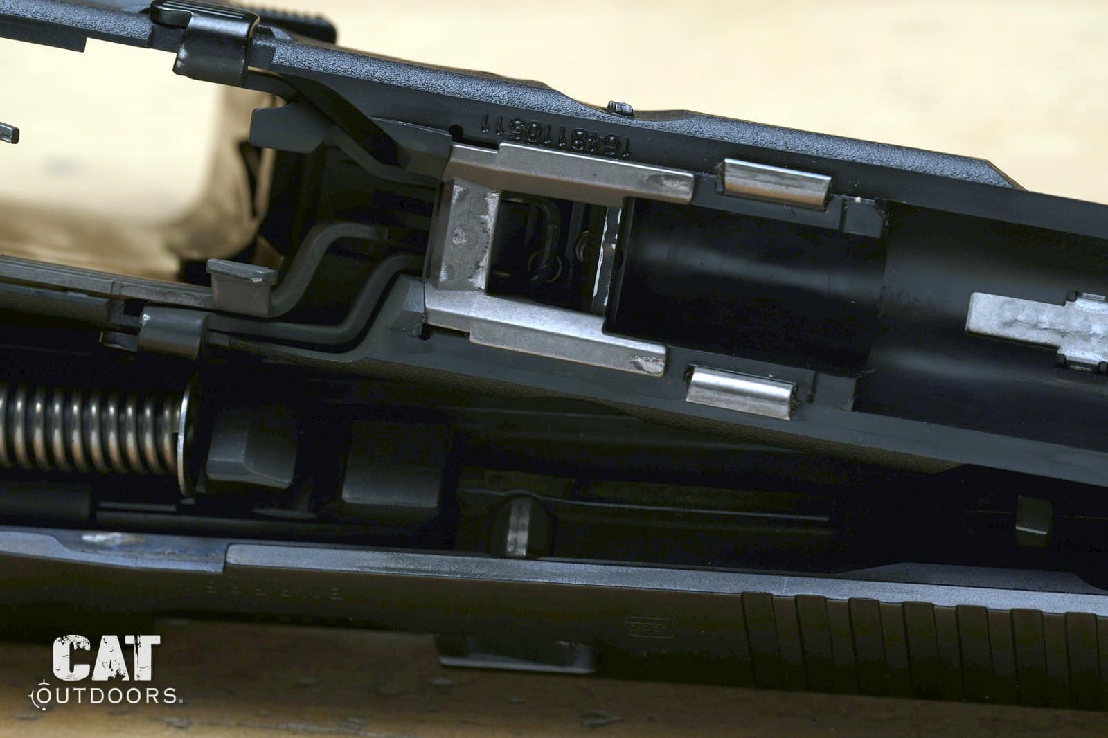 Macro of the Glock 19 Gen 5 frame rails and locking block showing polished wear after about 1,800 rounds