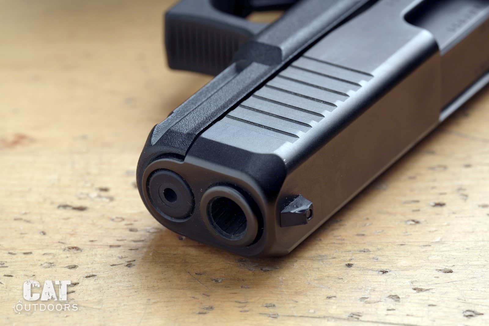 Muzzle end of the Glock 19 Gen 5 showing the recessed barrel crown, front serrations and nDLC finish after two years