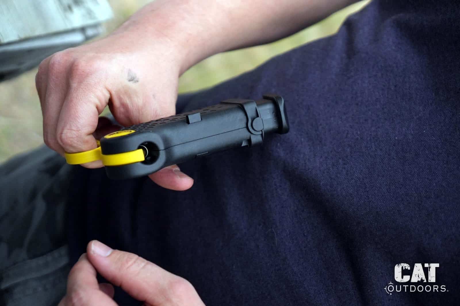 Pressing a round into the Speed Beez loader at the range bench, magazine locked in