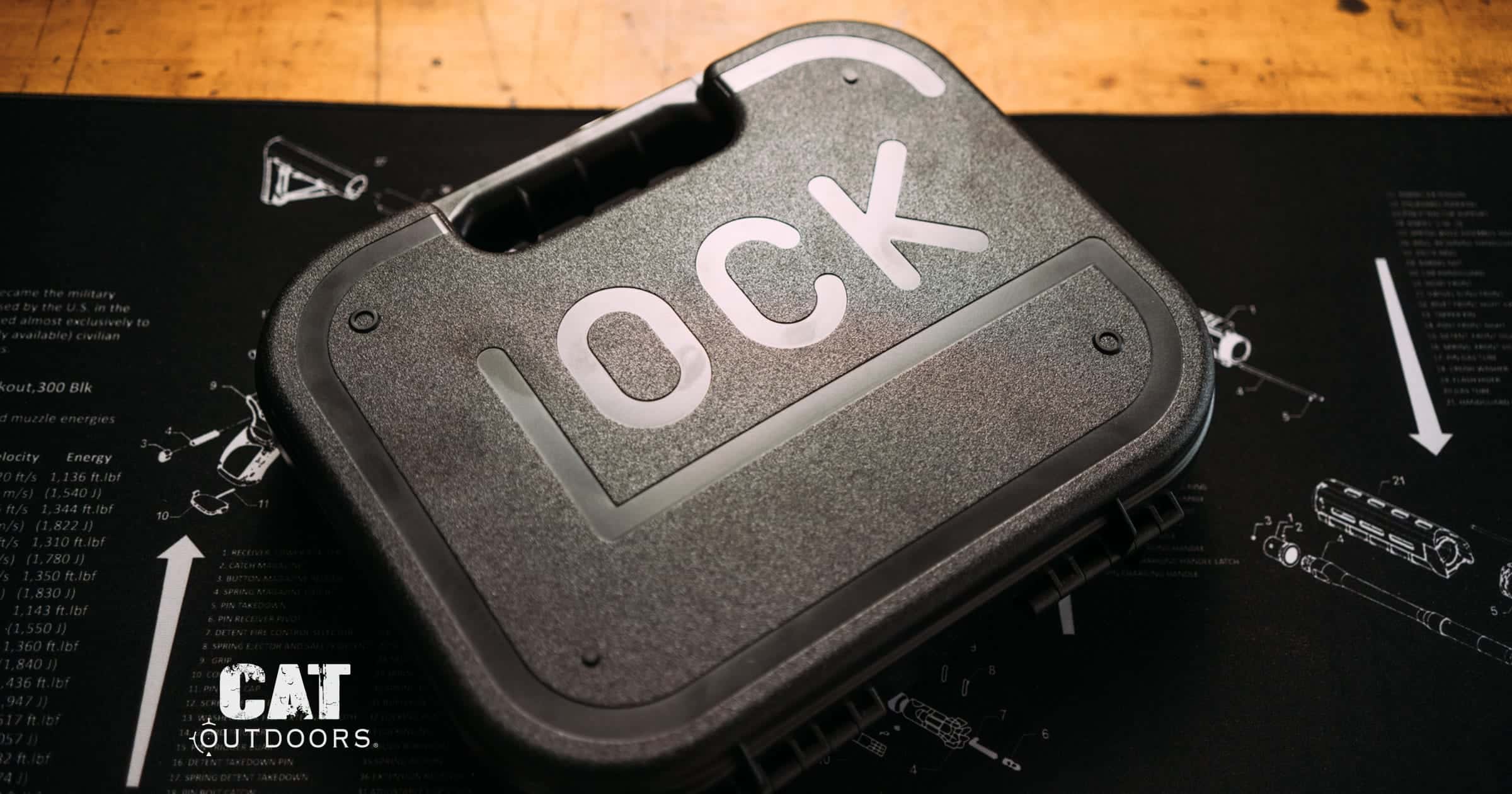 Glock pistol case closed on a workbench gun mat