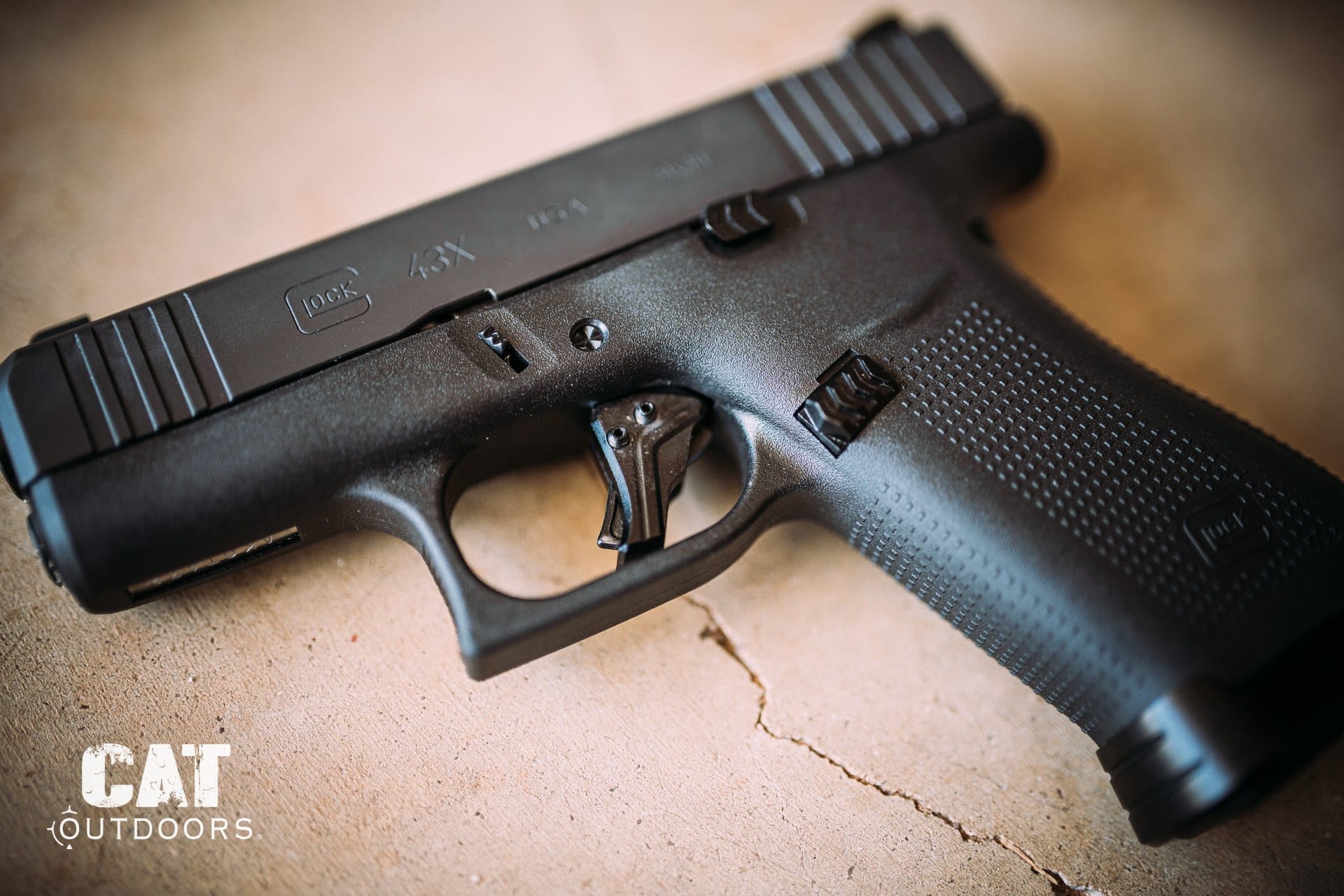 Glock 43X 9mm pistol on a workbench