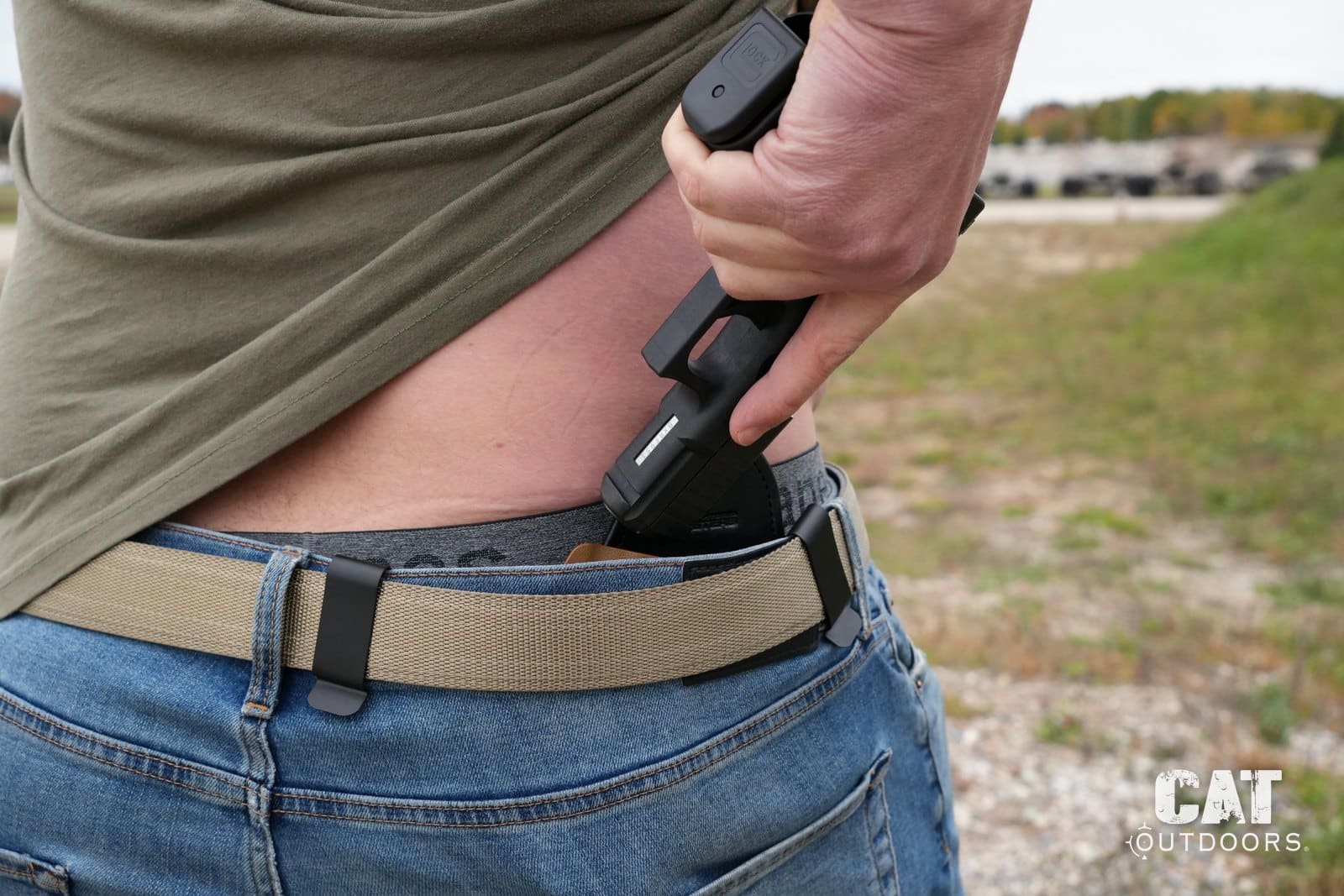 Reholstering a Glock 19 into the Hidden Hybrid Double Clip behind the hip, seen from above