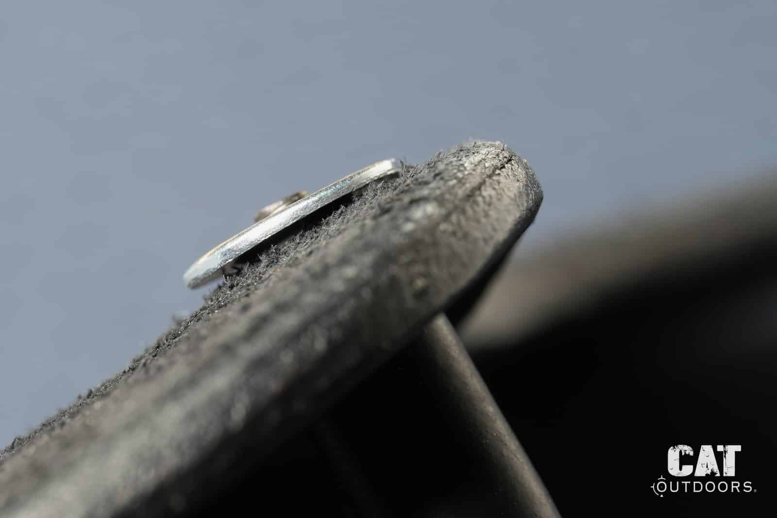 The long Hidden Hybrid retention screw poking past the grommet on the leather side