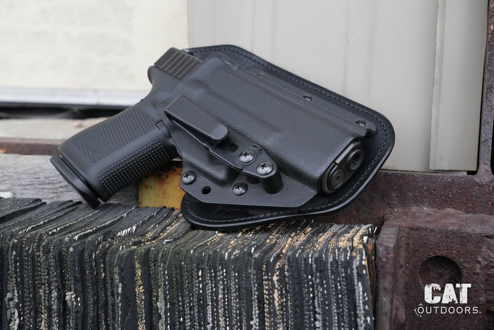 Hidden Hybrid holster review: the Single Clip IWB with a Glock 19 on a rusted steel bench