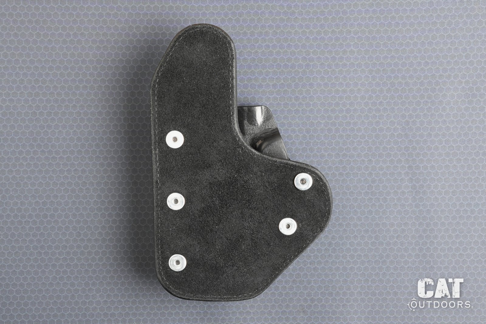 Suede leather backer of the Hidden Hybrid holster with its grommets and screw heads