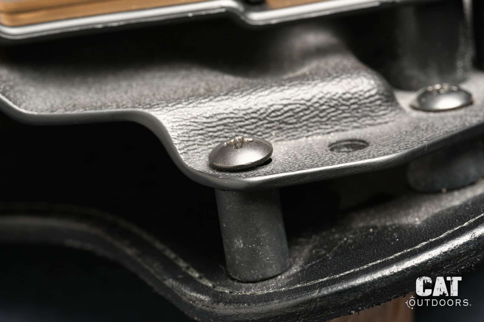 Close-up of the Hidden Hybrid retention screw and rubber spacer between the Kydex and the leather