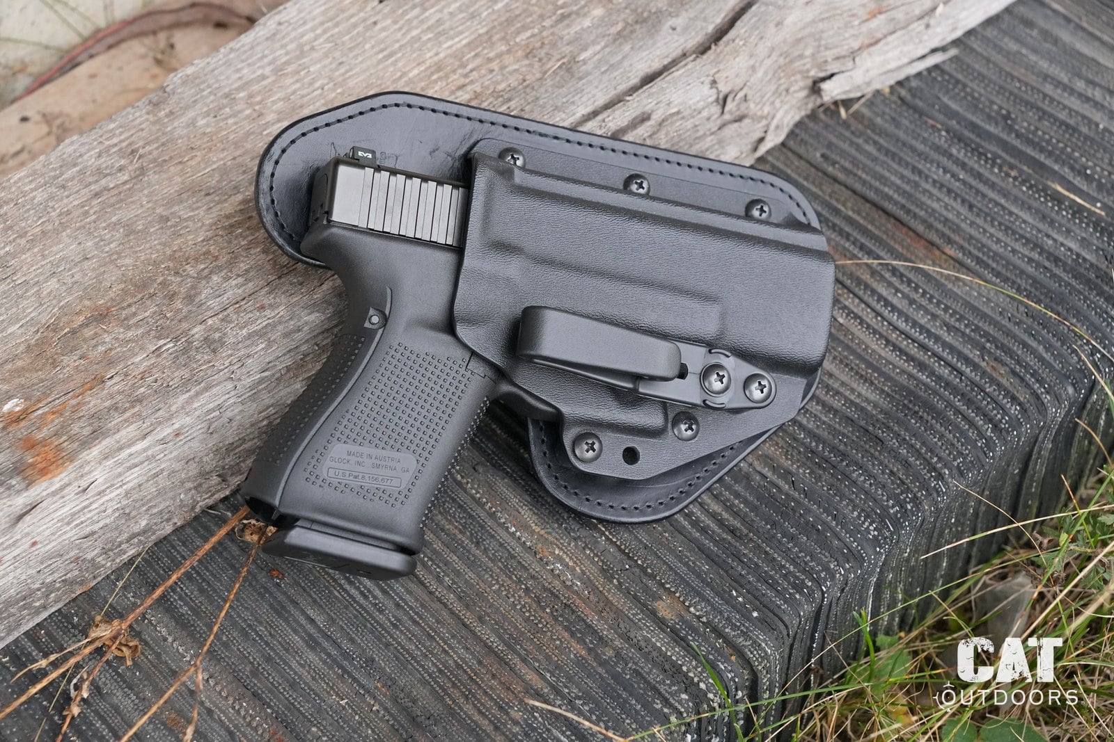 Hidden Hybrid Single Clip IWB holster with a Glock 19 on weathered wood