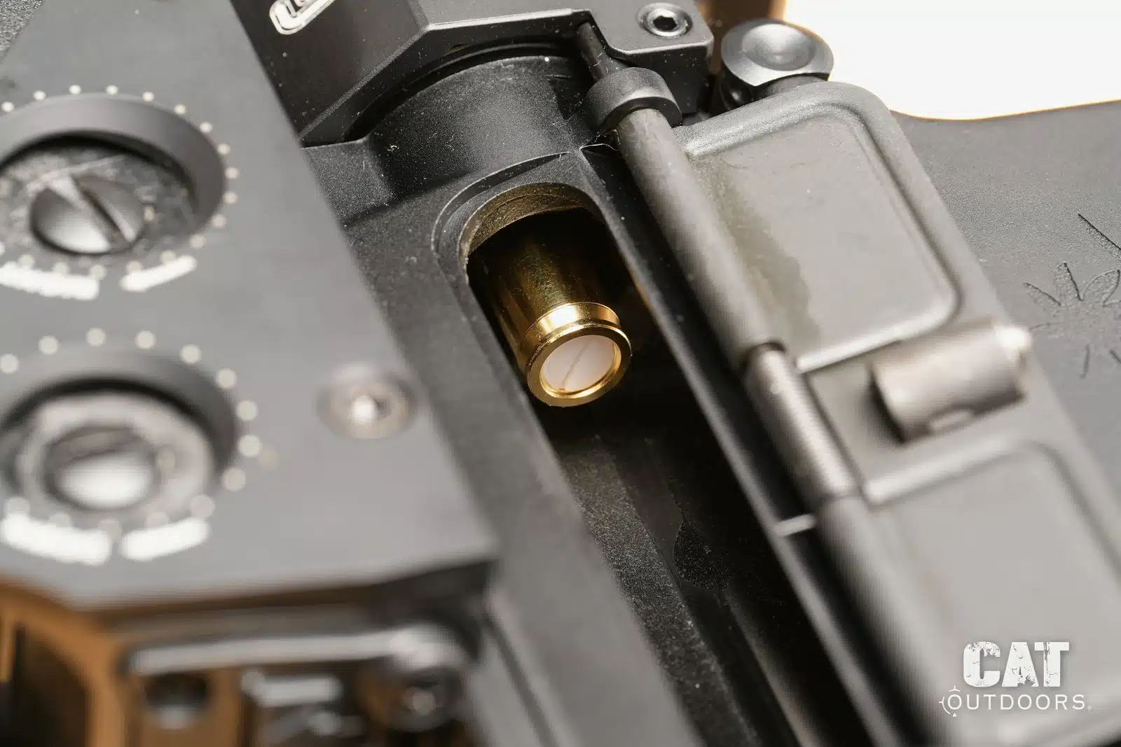 Sight-Rite laser bore sighter sitting in the chamber of a 5.56 AR-15, seen through the ejection port