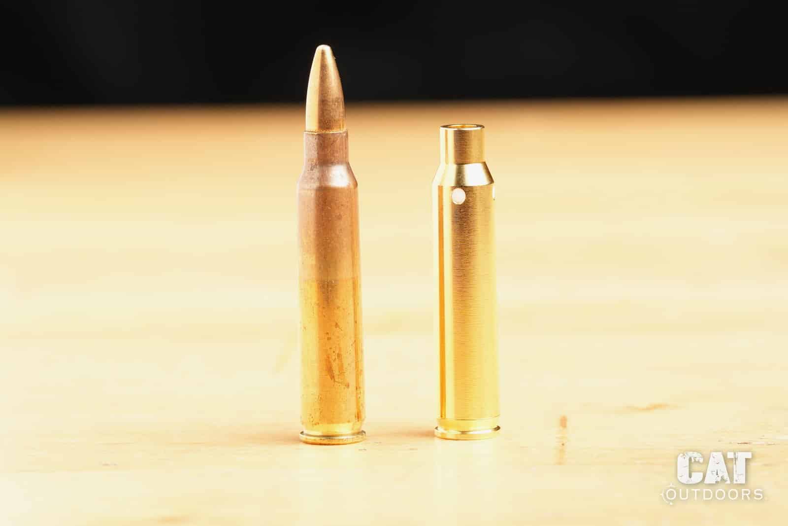 Sight-Rite laser bore sighter standing next to a loaded .223 round