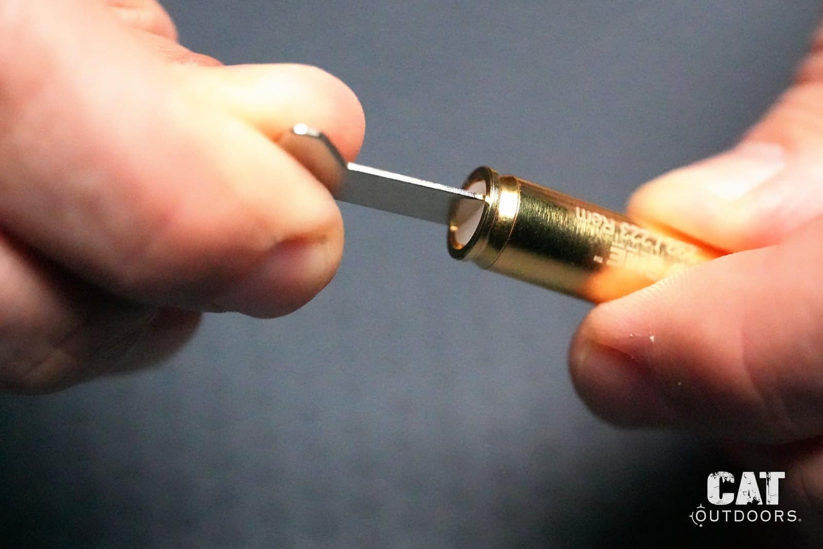 Turning the Sight-Rite laser bore sighter on with the included keyring tool
