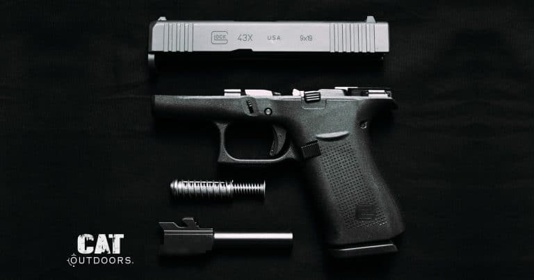 Field-stripped Glock 43X pistol showing the slide, frame, recoil spring, and barrel