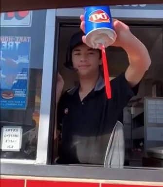 Kid flipping a Dairy Queen blizzard upside down