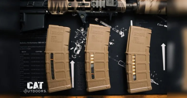 AR-15 rifle and three 30-round Magpul PMAG magazines on a workbench mat